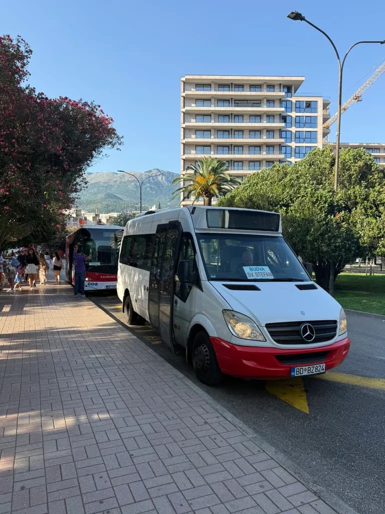 A Mediteran Express minibus at a stop on the Budva Riviera — the smaller bus that runs the same local routes.
